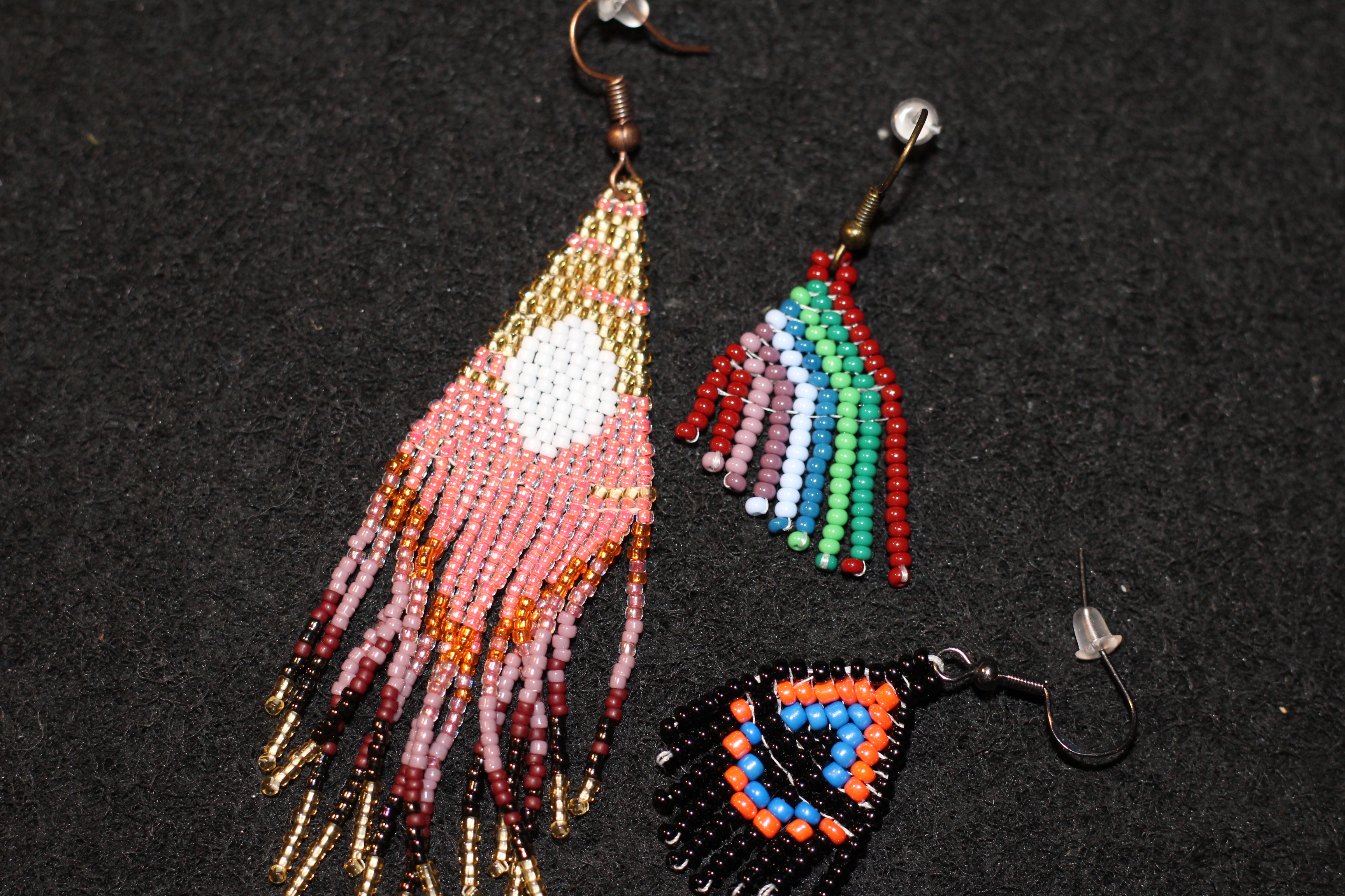 Three beaded earrings; two small earrings and one large.